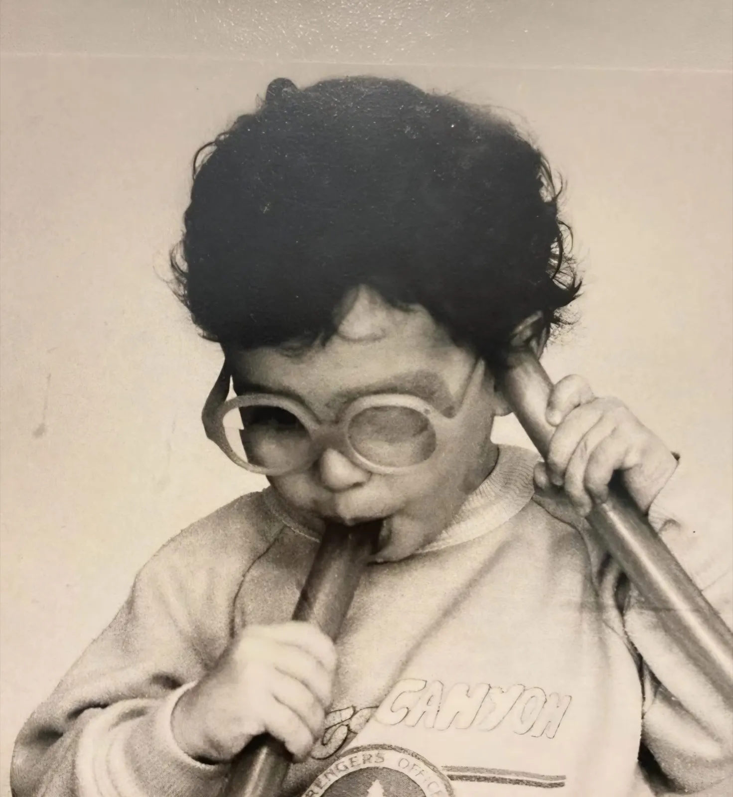 Lorenzo as a child, holding a drumstick
